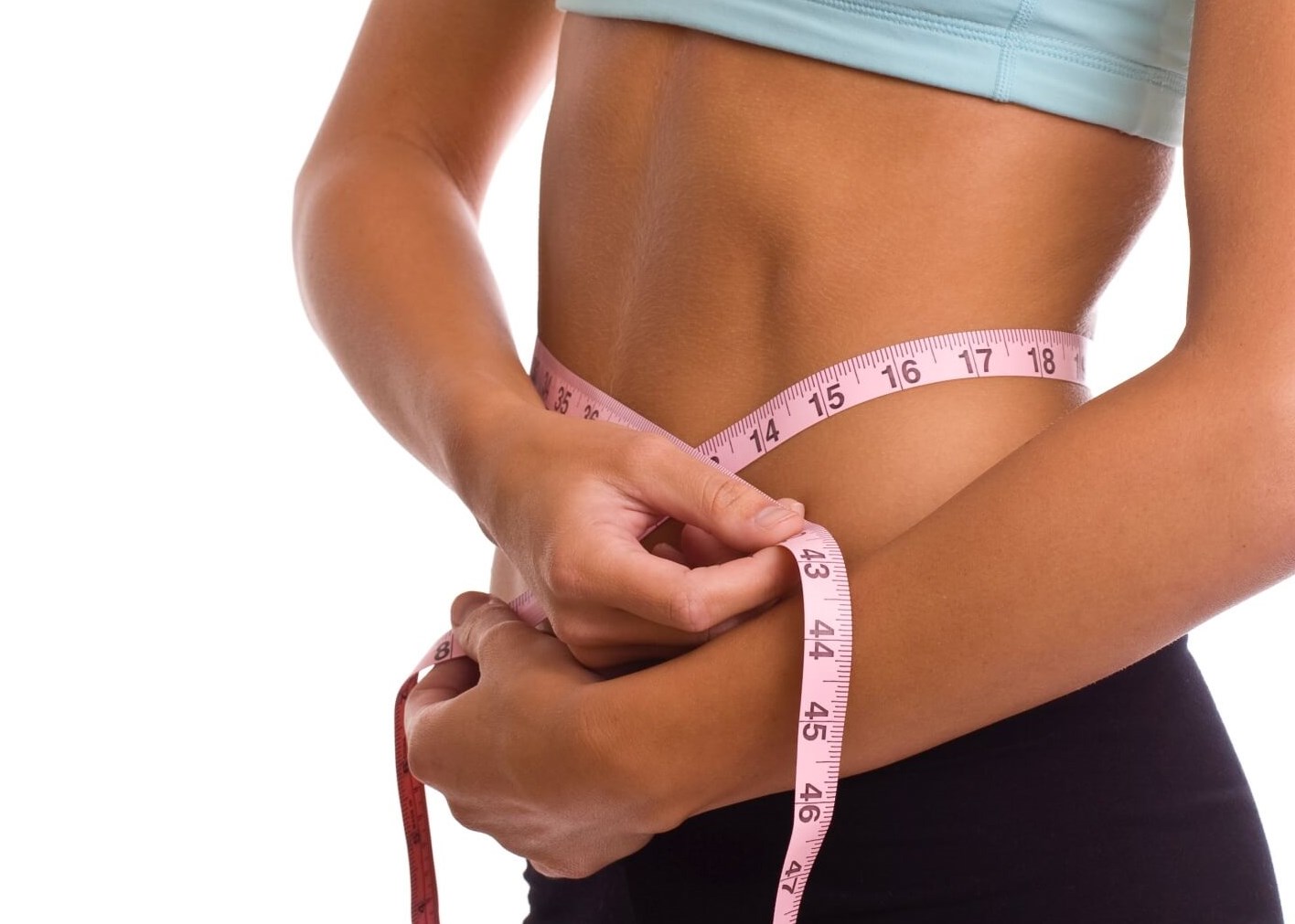 woman measuring her waist